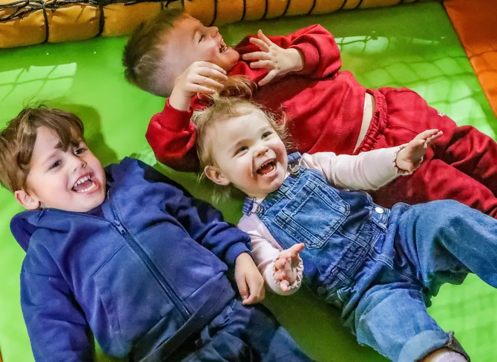 Kids laughing on soft play mat