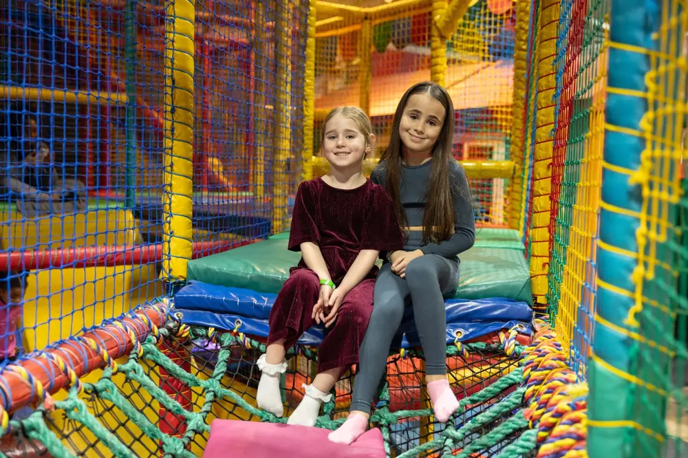 Friends smiling in play frame